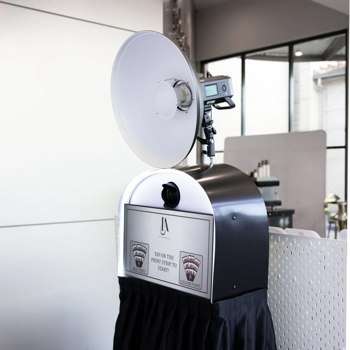 The photobooth with its studio strobe and touch screen
