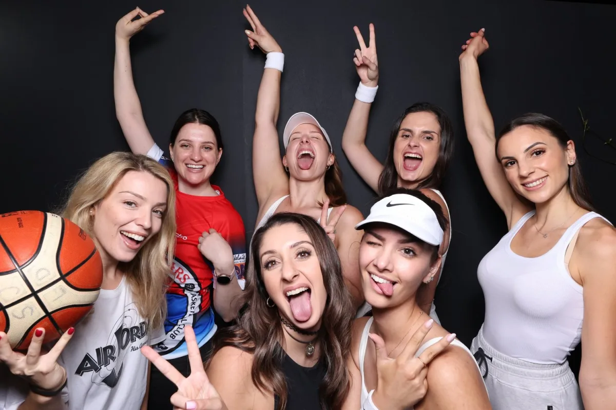 A group of friends mid-pose in the photobooth
